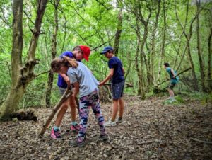 TRIBE Bushcraft child adventure day session constructing a new mini shelter