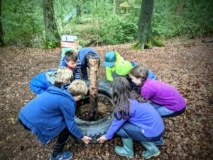 TRIBE Bushcraft child adventure day session lifting a tyre on the tyre problem solving challenge