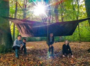 TRIBE Bushcraft child birthday party children showing their completed tarp shelter 1