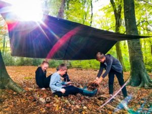 TRIBE Bushcraft child birthday party children showing their completed tarp shelter 2