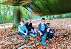 TRIBE Bushcraft child birthday party children showing their completed tarp shelter 3