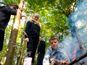 TRIBE Bushcraft child birthday party making a fire to cut though string