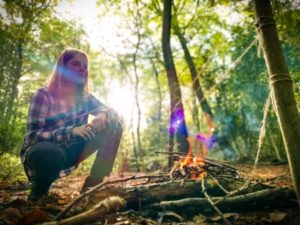 TRIBE Bushcraft child discovery day session child making fire to cut through string