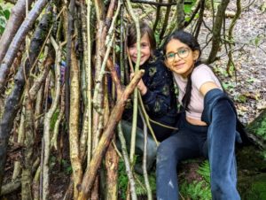 TRIBE Bushcraft child discovery day session children in their mini shelter
