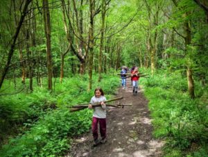 TRIBE Bushcraft home school education session carrying logs to main camp 1