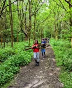 TRIBE Bushcraft home school education session carrying logs to main camp 2