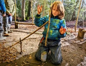 TRIBE Bushcraft home school education session child demonstrating a completed adjustable pot hook