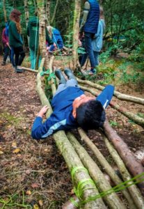 TRIBE Bushcraft home school education session child lying on a stick hammock