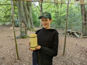 TRIBE Bushcraft home school education session child showing the completed split wood cup 1