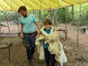 TRIBE Bushcraft home school education session child wearing a reindeer skin