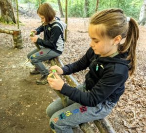 TRIBE Bushcraft home school education session children demostrating a knife cutting technique