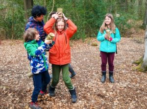 TRIBE Bushcraft home school education session children showing off their completed split log cups