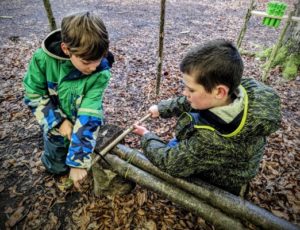 TRIBE Bushcraft home school education session correct method being demonstrated by children on how to cut wood