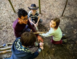 TRIBE Bushcraft home school education session cutting a log to length using the buck saw