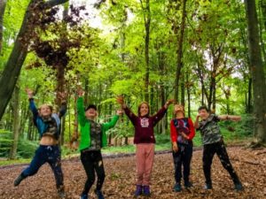 TRIBE Bushcraft session adventure day jumping for joy in the woodland