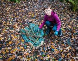 TRIBE Bushcraft session birthday party using a tarp to transport the sticks