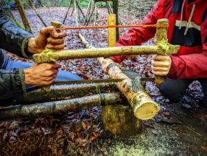 TRIBE Bushcraft session closeup of the buck saw being used