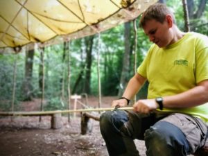 TRIBE Bushcraft session instructor using the peeling technique