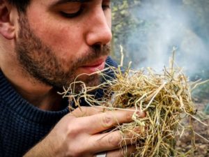 TRIBE Bushcraft session social saturdays adult bushcraft blowing an ember to flame