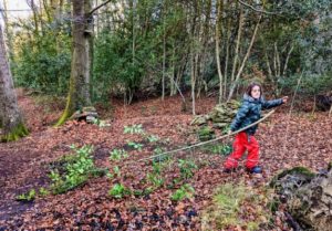 TRIBE Bushcraft session social saturdays family bushcraft child carrying long branch