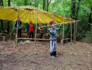 TRIBE Bushcraft session social saturdays family bushcraft child demonstrating how to throw an atlatl