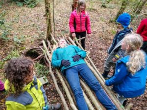 TRIBE Bushcraft session social saturdays family bushcraft children and an adult testing out the stick hammock 2