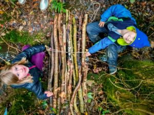 TRIBE Bushcraft session social saturdays family bushcraft children demonstrating their bridge