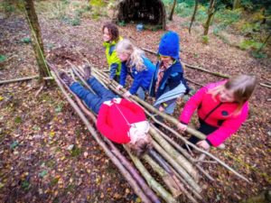 TRIBE Bushcraft session social saturdays family bushcraft children testing out the stick hammock 3