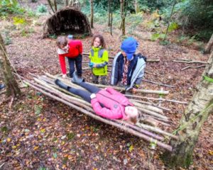 TRIBE Bushcraft session social saturdays family bushcraft children testing out the stick hammock 4