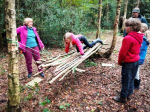 TRIBE Bushcraft session social saturdays family bushcraft children testing out the stick hammock 6