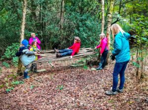 TRIBE Bushcraft session social saturdays family bushcraft children testing out the stick hammock 8