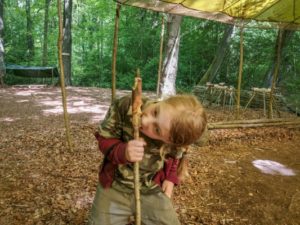 TRIBE Bushcraft session social saturdays family bushcraft eating a bread twist from a stick