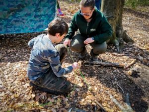 TRIBE Bushcraft session social saturdays family bushcraft instructor showing child how to tie a knot