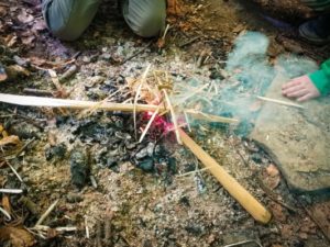 TRIBE Bushcraft session social saturdays family bushcraft playing with making fire using the embers from a fire