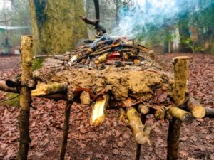 TRIBE Bushcraft session social saturdays family bushcraft raised fire being used 2