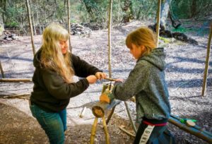 TRIBE Bushcraft session social saturdays family bushcraft using an auger to form a hole for a mallet