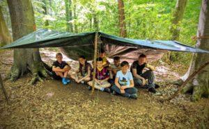 TRIBE Bushcraft youth group completing the shelter
