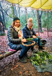 TRIBE Willow wreath winter workshop 2 adults adding decorations to their willow wreaths