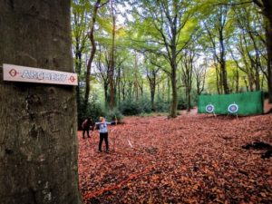 TRIBE Woodland Archery TRIBE sign and archers in the background