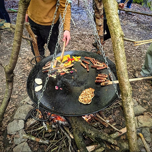 TRIBE cooking food for the group 1